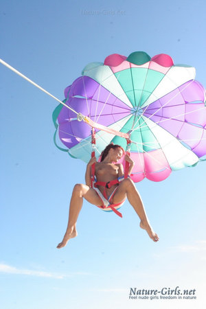 Asian solo girl Lily Love freeing small tits from cosplay uniform outdoors